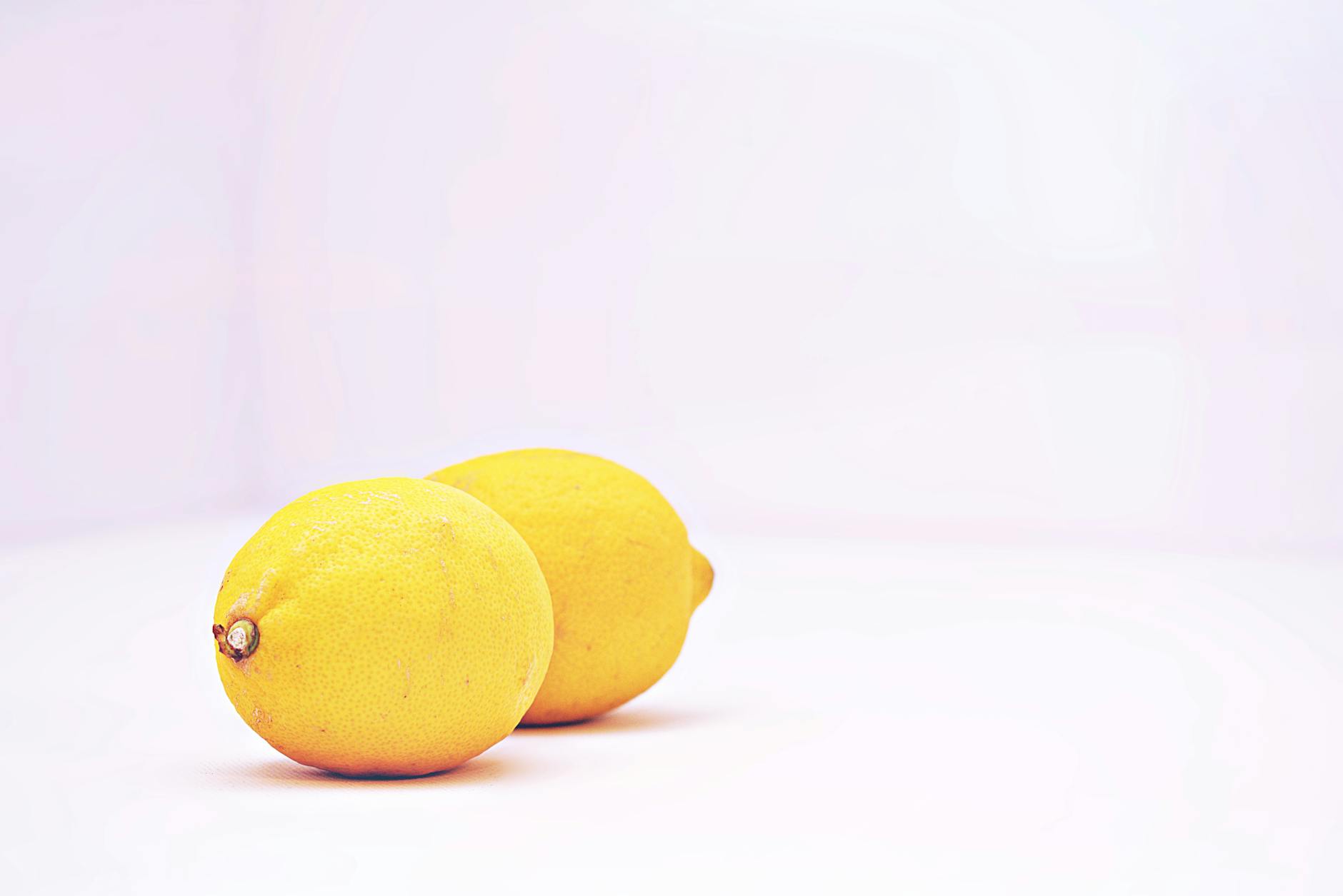 Two vibrant lemons against a white background symbolizing the transition and shifting sensation of perimenopause