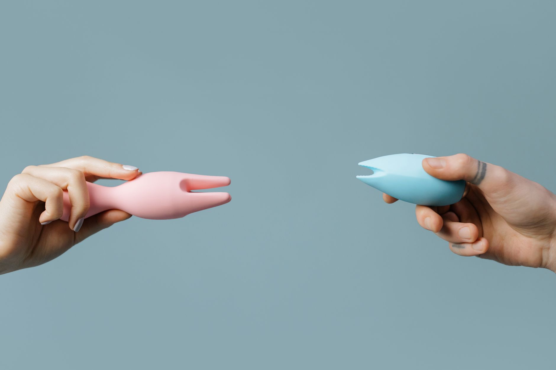 Hand holding a fresh lemon on a soft pink background, representing natural cycle phases.
