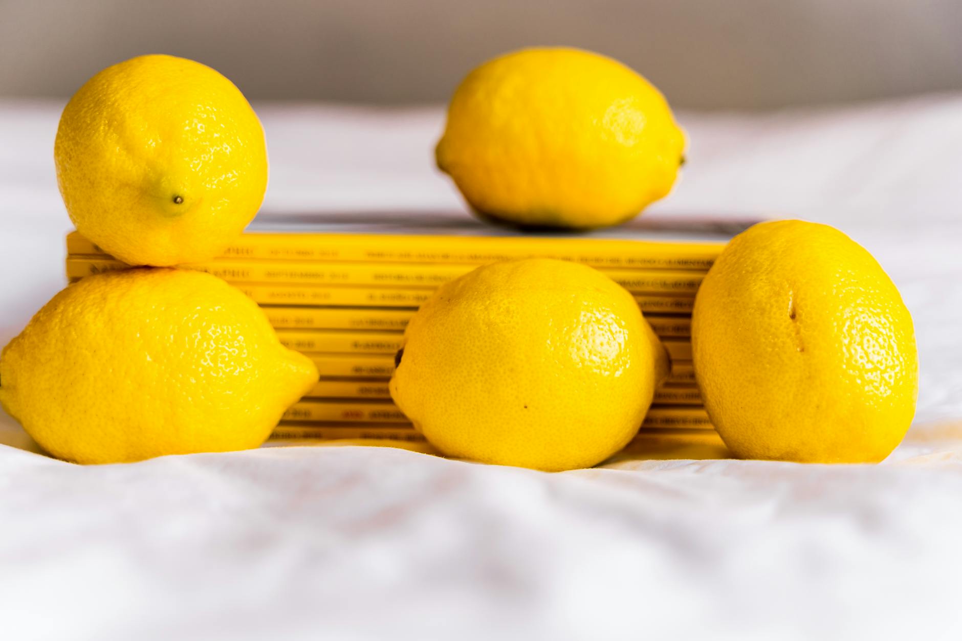 Vivid yellow lemons arranged on a yellow background, symbolizing brightness and clarity about PCOS and pleasure